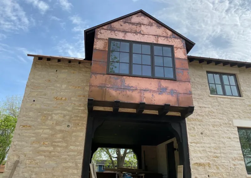 Copper metal panel facade on a stone building for Skylight Installation in Great Barrington